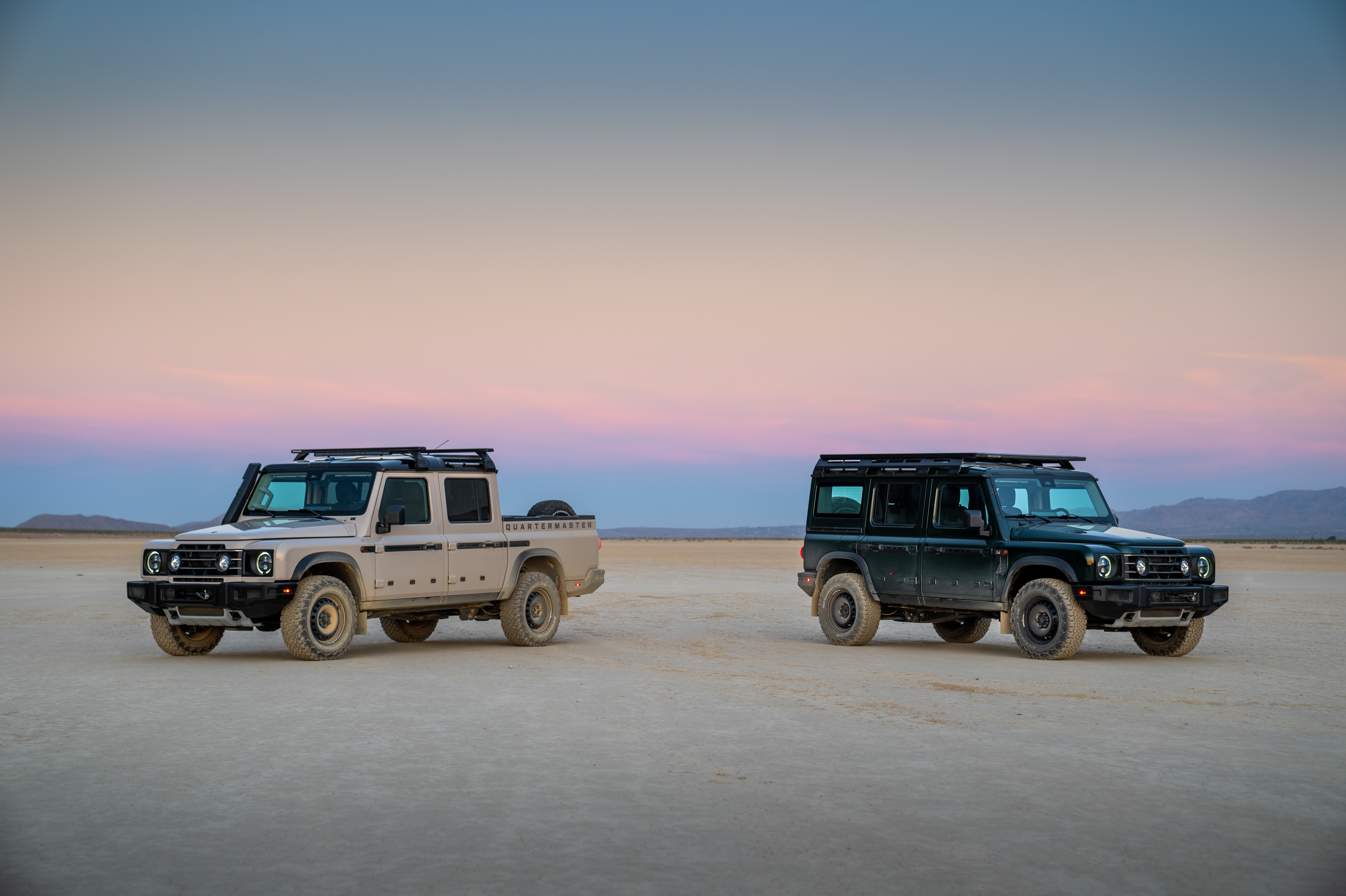 INEOS Grenadier Station Wagon ו‑Quartermaster עומדים במישור מדברי בשעת דמדומים